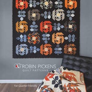 May include: A quilt pattern titled PASADENA ROSES by ROBIN PICKENS QUILT PATTERNS. The design features a grid of stylized rose blocks in orange, blue, and black, interspersed with leaf motifs. A second quilt with a cream background is shown.