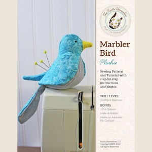 May include: A sewing pattern for a blue and gray marbler bird plushie. The pattern includes step-by-step instructions and photos. The pattern is for a confident beginner and includes three tail options. The plushie can be made into a mobile or a pin cushion.