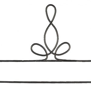May include: A black metal towel rack with a decorative top featuring a stylized floral design. The rack has a horizontal bar for hanging towels and is designed for bathroom use.