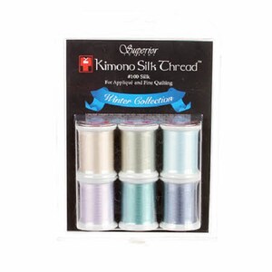 May include: Six spools of Superior Kimono Silk Thread in a Winter Collection. The spools are in shades of white, light blue, lavender, and teal.