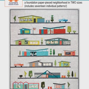 May include: A fabric quilt featuring a colorful, mid-century modern neighborhood design. The quilt showcases various buildings, cars, and trees in a row, with the text "Atomic Avenue" and "Hunter's Design Studio" in the upper left corner. The quilt includes seventeen individual patterns.