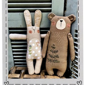 May include: Two 14-inch tall stuffed toys: a bear and a bunny. The bear is brown with embroidered details, and the bunny is beige with a polka-dot belly. The image includes the text "#400 Forest Friends - Bear & Bunny" and "Heart to Hand".