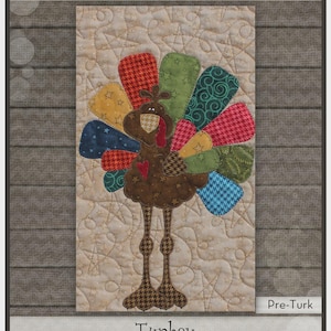 May include: A colorful turkey appliqué on a beige quilted background. The turkey features a brown body, patterned legs, and a variety of patterned feathers in red, green, blue, and yellow. The text "Turkey" is at the bottom.