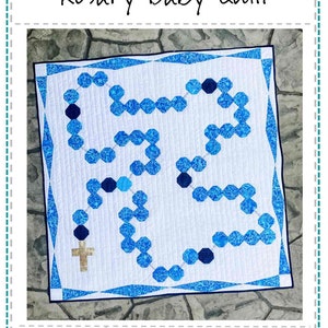 May include: A quilt pattern for a Rosary Baby Quilt, designed by Jen Frost. The pattern features a blue and white rosary design with a cross at the bottom. The quilt is 39 inches by 39 inches.