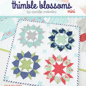 May include: A mini quilt pattern called "Thimble Blossoms" by Camille Roskelley. The pattern features four different blocks with a starburst design in shades of blue, green, red, and gray. The quilt is labeled "swoon #170".