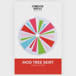 May include: A white Mod Tree Skirt sewing pattern with a colorful geometric design. The design features red, pink, green, and blue triangular shapes radiating from the center. The text "MOD TREE SKIRT" is displayed on a red banner.