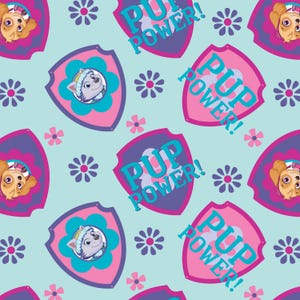 May include: A blue and pink repeating pattern featuring a cartoon dog with a pink collar and a purple shield with the text "Pup Power!" in blue and pink letters. The background is light blue with pink and purple flowers.
