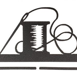 May include: Black metal wall hook shaped like a spool of thread with a needle and thread. The hook is designed to hold items like scarves, belts, or jewelry.