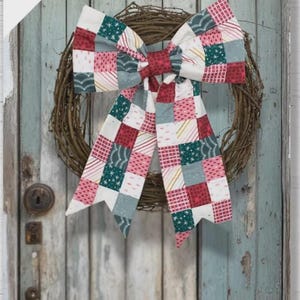 May include: A decorative bow featuring a patchwork design with squares in shades of red, green, white, and grey, attached to a circular twig wreath. The text 'knot' your average bow and a single-fabric or patchwork bow in two sizes is visible.