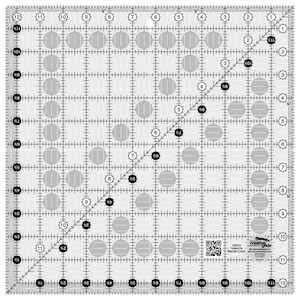 May include: A clear plastic quilting ruler with a grid pattern and circles of varying sizes. The ruler is marked with inches and fractions of an inch. The ruler is designed for quilting and sewing projects.