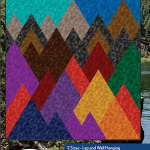 May include: A quilt pattern featuring a mountain range with a variety of colors, including teal, brown, gray, purple, red, green, yellow, and orange. The pattern is called "Mountains" and is by Swirly Girls, featuring Rapture - Dazzling Color Mood by QT Fabrics.