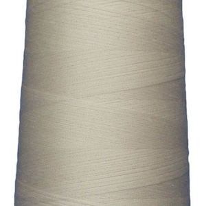 May include: A large spool of beige thread.
