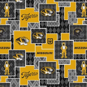 May include: A repeating pattern featuring the Missouri Tigers logo, mascot, and text. The design incorporates gold, black, and gray elements, including the word "Tigers" and the team's tiger head logo. The background has a diamond pattern.