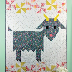 May include: A quilt pattern featuring a stylized goat with a floral print. The quilt is surrounded by a border of yellow, red, and white pinwheels. The quilt is titled "Delilah #SGD054" and is a pattern by "Swirly Girls".