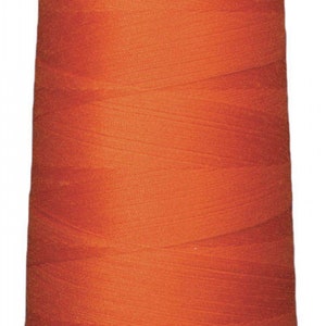 May include: A spool of orange thread.