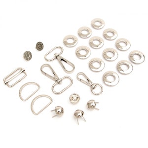 May include: Assortment of silver metal hardware for crafting, including grommets, D-rings, swivel clasps, and studs.