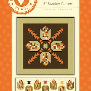 May include: A quilt pattern titled "Let's Pop Some Corn" by Sandy Gervais. The pattern is a 5-inch Stacker pattern and features a brown background with a design of corn cobs in a starburst pattern. The pattern also includes a border of corn cobs.