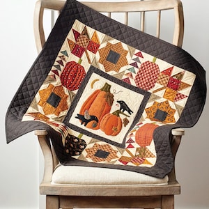 May include: A quilt pattern featuring a pumpkin patch design with two crows and a crescent moon. The quilt is 30 inches by 30 inches and is called "Pumpkin Patch Quilt".