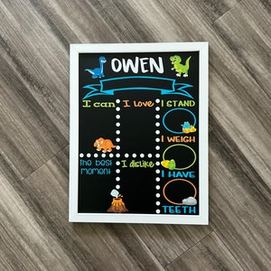 Puede incluir: Una pizarra negra con marco blanco, con tem&aacute;tica de dinosaurios. La pizarra tiene un t&iacute;tulo que dice "OWEN" e incluye las frases "Puedo", "Me encanta", "Me pongo de pie", "Peso", "Tengo", "El mejor momento", y "No me gusta".