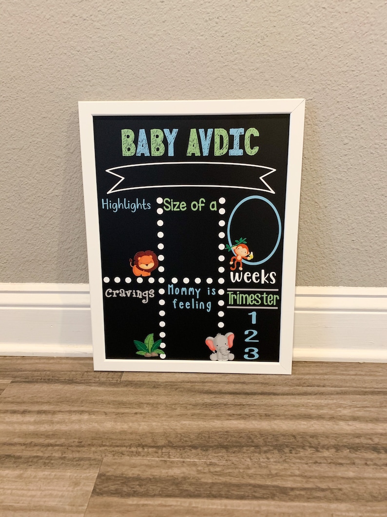 K&ouml;nnte beinhalten: Eine schwarze Tafel mit wei&szlig;em Rahmen, betitelt "BABY AVDIC". Die Tafel ist in Abschnitte mit den &Uuml;berschriften "Highlights", "Gr&ouml;&szlig;e eines", "Gel&uuml;ste", "Mama f&uuml;hlt sich", "Wochen" und "Trimester" unterteilt. Es gibt Illustrationen von einem L&ouml;wen, einem Affen und einem Elefanten.