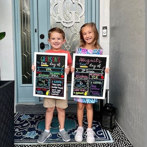 Shows children holding milestone chalkboard signs that are reusable to document milestones for the first and last day of school.