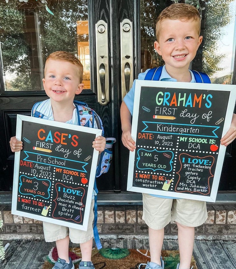 Shows children holding milestone chalkboard signs that are reusable to document milestones for the first and last day of school.