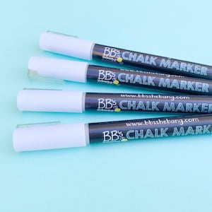 May include: Four white chalk markers with black caps and labels that read "BB's Chalk Marker" and "www.bbsshebang.com".