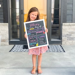 Shows child holding a milestone chalkboard sign that is reusable to document milestones for the first and last day of school.