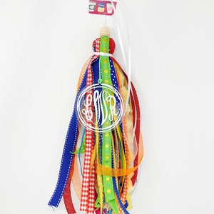 May include: A colorful tassel keychain with a white monogram "LSA" in a clear circle. The tassel is made of various ribbons in red, blue, green, yellow, and orange.