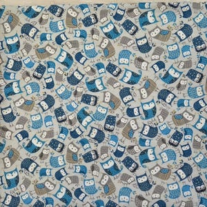 May include: A fabric with a repeating pattern of owls in shades of blue, gray, and brown on a light gray background. The owls have various designs and expressions, creating a whimsical and decorative textile.