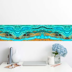 May include: A vibrant, abstract wall art piece with a repeating pattern of turquoise, teal, and gold tones. The design resembles a cross-section of layered stone or mineral formations. The artwork is displayed above a white desk with office supplies and a vase of blue flowers.