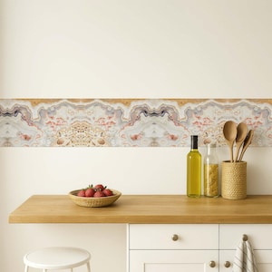 May include: A kitchen scene featuring a wooden countertop with a woven bowl of strawberries, olive oil bottles, and wooden spoons in a woven holder. A decorative border with a marble design is above the countertop.