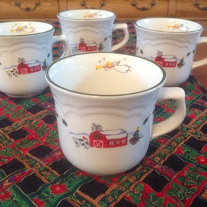 Four (4) Pfaltzgraff SNOW VILLAGE Coffee / Tea Cups - Red Barn and Trumpeting Angel