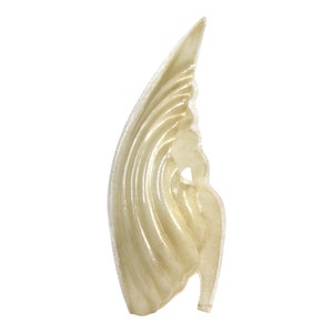May include: A white, translucent, abstract sculpture with a wavy, organic shape. The sculpture is made of a smooth, glossy material and has a delicate, ethereal appearance.