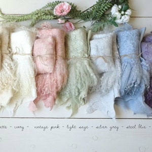 May include: Seven different colors of fluffy, faux fur fabric swatches, tied with twine. The colors are morning latte, ivory, vintage pink, light sage, silver grey, steel blue, and lavender.