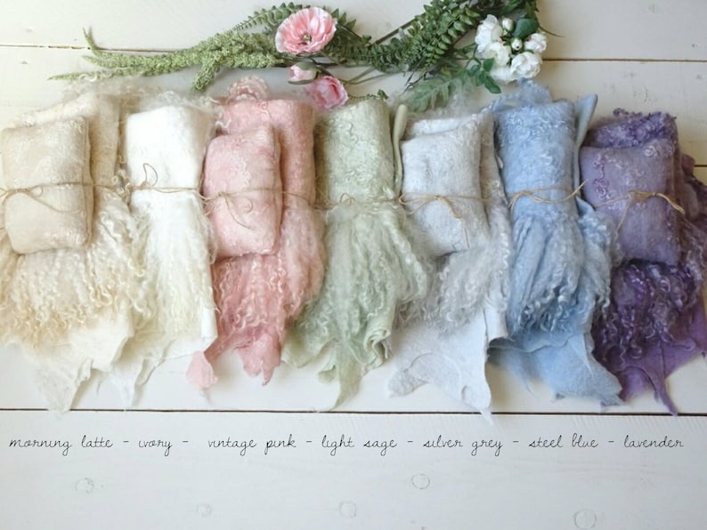 May include: Seven different colors of fluffy, faux fur fabric swatches, tied with twine. The colors are morning latte, ivory, vintage pink, light sage, silver grey, steel blue, and lavender.