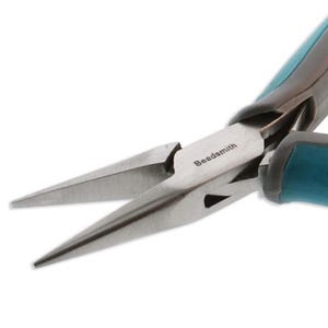 May include: Close-up of silver needle nose pliers with teal handles. The pliers, labelled "Beadsmith", are designed for jewellery making and crafting. The tool is set against a white background.