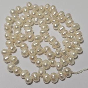 6~7x4~5 mm geboorde rijstparels aan de zijkant, wit, 14,5" streng