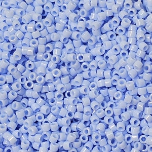May include: A large quantity of small, light blue glass seed beads. The beads are round with a hole in the centre.