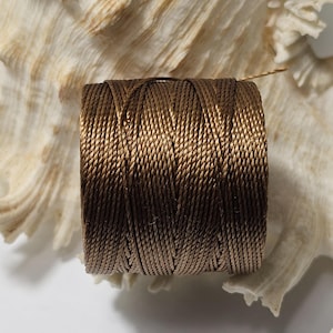 May include: A spool of brown waxed cord, ideal for crafting and jewellery making.