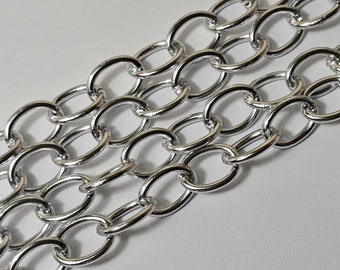 May include: A silver chain with oval links. The chain is made of metal and has a shiny finish.