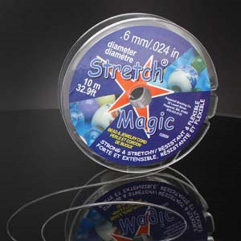 May include: A clear plastic spool of 0.024 inch diameter stretch magic bead and jewelry cord. The spool is labeled with the text "Stretch Magic" and "10 m 32.9ft".