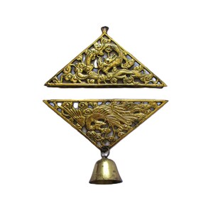 May include: Two triangular gold-colored metal ornaments featuring intricate openwork carvings. The top piece depicts a dragon, while the bottom piece displays a phoenix and is attached to a small, smooth, conical bell hanging from a metal loop.