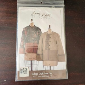 May include: A sewing pattern envelope by Anna Claire Originals for an Indygo Junction, Inc. Eyelet Appeal Jacket, size S-XL. The cover displays two jacket variations on dress forms: one in a dark floral print and one in a solid tan fabric.