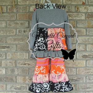 May include: A gray long-sleeve top and patterned pants set. The pants feature orange, pink, and black floral and swirl designs. The text "Back View" is visible above the outfit.