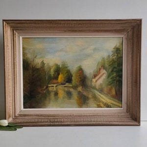 French vintage oil on canvas landscape painting of country riverside scene, signed and framed.