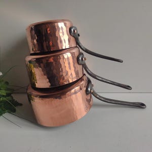 French vintage set of 3 Villedieu copper sauce pans, hammered with cast iron handles and stamps.