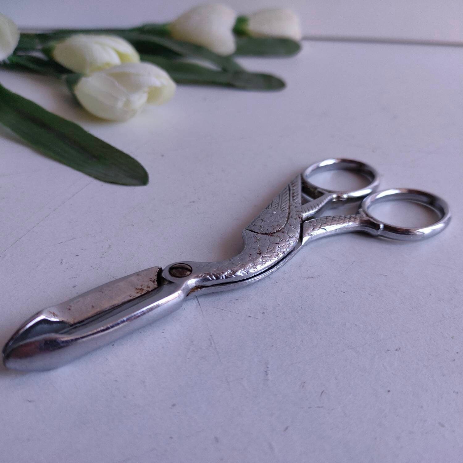 stork form and ornate finish. bird French vintage silvered metal grape