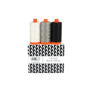 May include: Three spools of thread in white, gray, and black, each with an orange base, sit atop a box with a black, white, and gray geometric pattern. The box is labeled "Carrara Black/White."