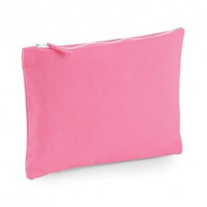 May include: A pink canvas zippered pouch. The pouch is made of a soft, textured fabric and has a zipper closure.